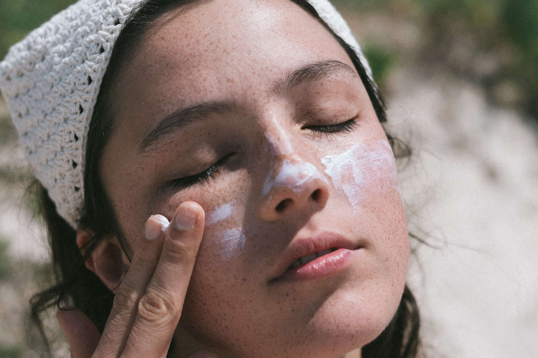 Girl using sunscreen